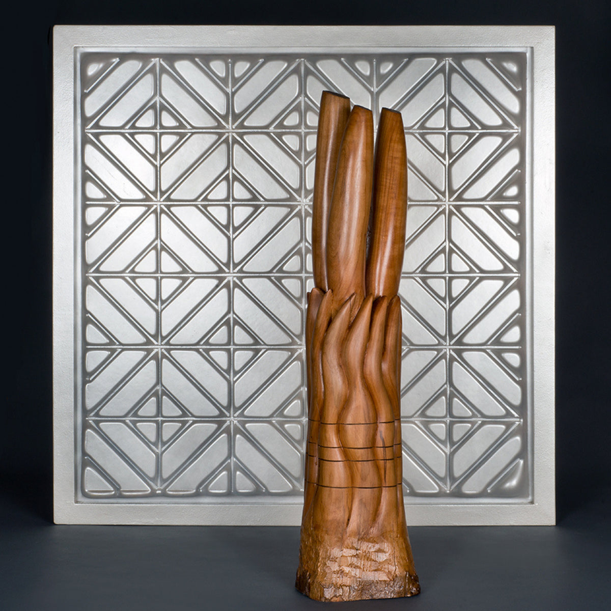 Grouping with white plastic vacuum-formed wall piece and "Wheat Field" wood sculpture by Peter Gohringer